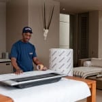 Pickfords staff wrapping a TV in specially-designed packaging.