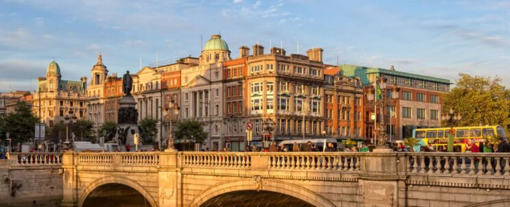 Traditional stone bridge in a picturesque Irish town A charming, historic town in Ireland featuring a stone bridge crossing a peaceful river, capturing the inviting atmosphere of the Irish countryside.